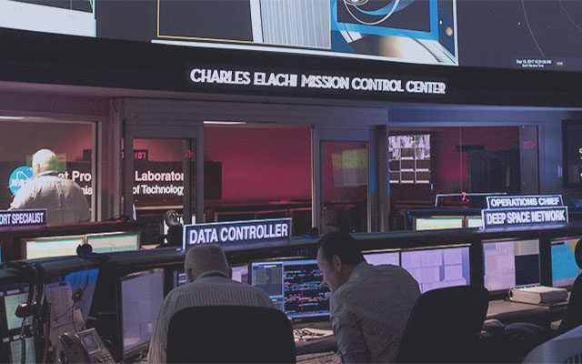 This image shows people working inside Mission Control.