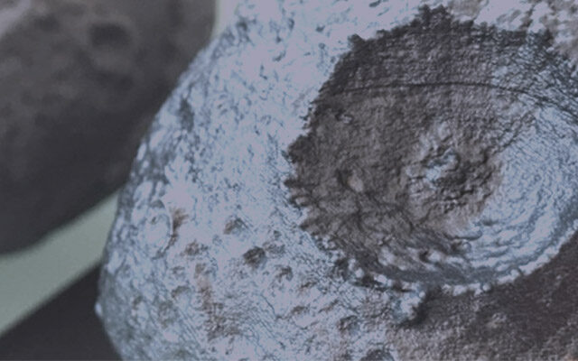This image shows two grey 3D-printed artist's conception of the Psyche asteroid.