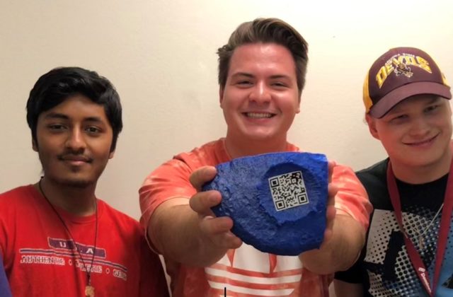 Psyche Student Collaborations show off a Psyche QR code that is attached to a section of a blue Psyche asteroid.