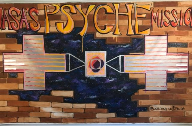 Psyche spacecraft breaking through a brick wall, opening to a vast and colorful universe.