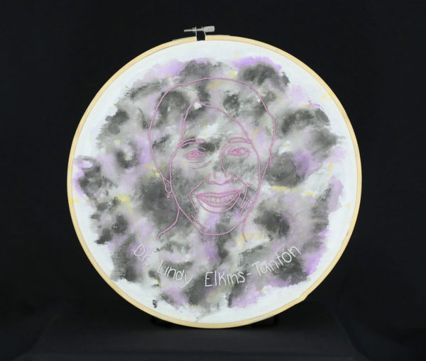 An embroidered portrait of Dr. Lindy Elkins-Tanton is centered on a watercolored image of Psyche.