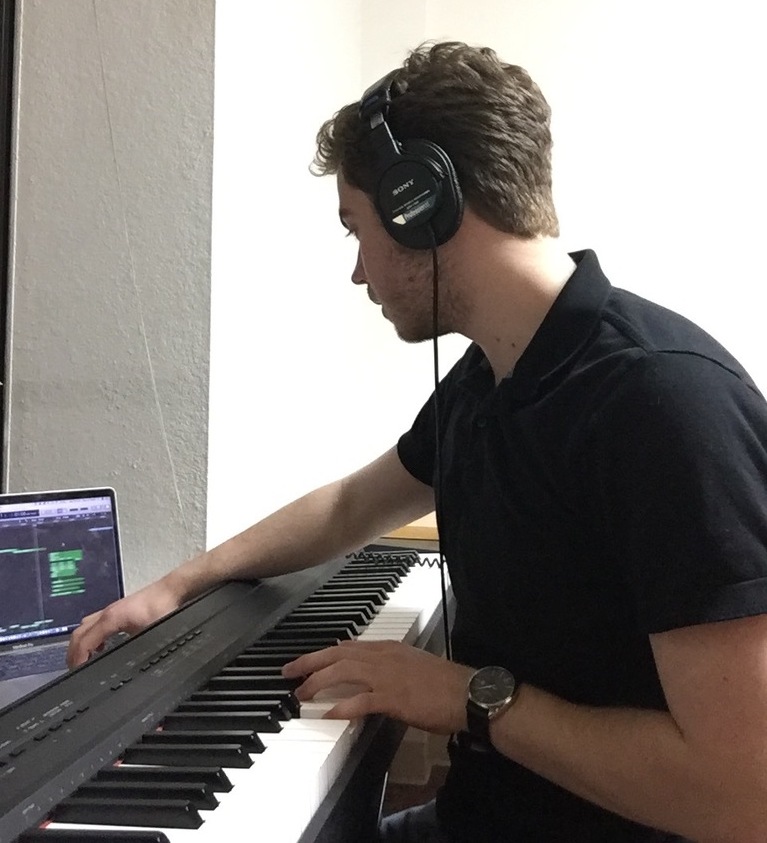 this image is of our Psyche Inspired intern Ryan Powell who playing the piano and editing his music of his computer.