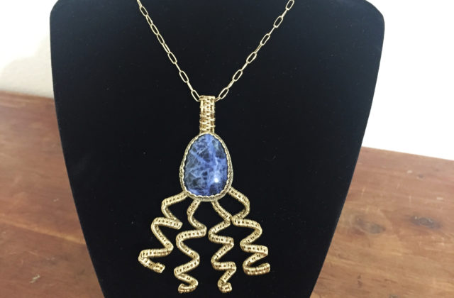 Sodalite stone with brass wire wrapped spiral embellishments.