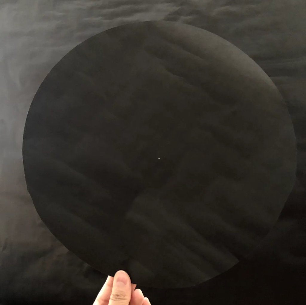 Black circle on black paper.