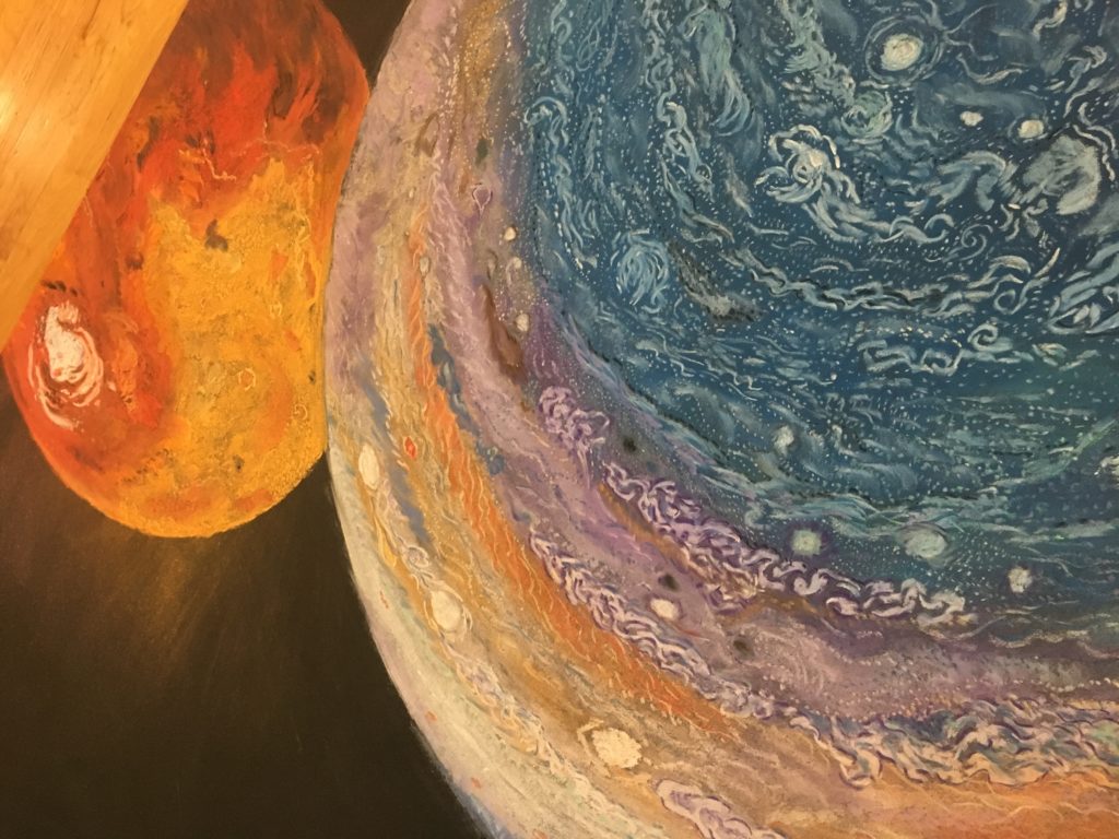 "Falling" is composed of pastel on a black sheet of wood. It is 6ft tall and 2ft wide. Most of the painting is black with a few scattered stars. Immense planets are found at the ends of the scene. A small purple and gold craft falls away from Earth at the top of the painting and down toward an equally miniscule target: 16-Psyche. This asteroid sits at the center of the painting, floating between Jupiter and Mars.