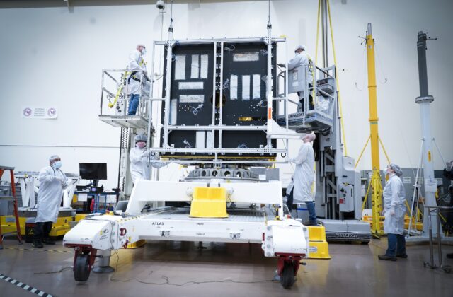 Scientists and engineers are working on the body of the Psyche spacecraft.