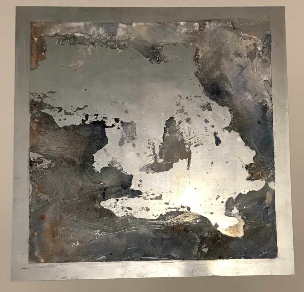 A metallic aluminum sheet with scattered abstract paste throughout the piece. The colors are grey, purple, and copper.