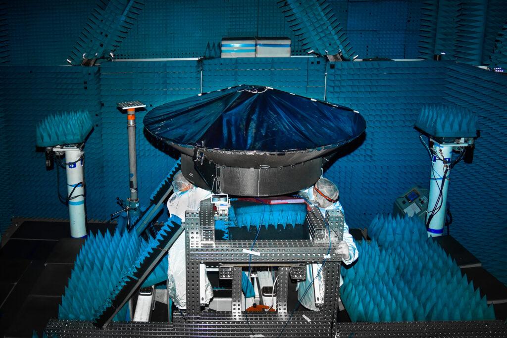 This image is of Psyche’s high gain antenna which is black and in surrounded by blue insulation.