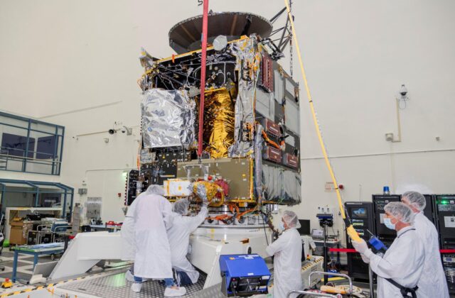 Engineers at NASA's Jet Propulsion Laboratory in Southern California work to integrate Hall thrusters into the agency's Psyche spacecraft in this July 2021 photo. One of the thrusters is visible on the side of the spacecraft beneath a red protective cover. Psyche is set to launch in August 2022 and will travel to its target, a metal-rich asteroid also named Psyche, under the power of solar electric propulsion. This super-efficient mode of propulsion uses solar arrays to capture sunlight that is converted into electricity to power the spacecraft's Hall thrusters. They work by turning xenon gas, a neutral gas used in car headlights and plasma TVs, into xenon ions. As the xenon ions are accelerated out of the thruster, they create the thrust that will propel the spacecraft. This will be the first use of Hall thrusters beyond lunar orbit, demonstrating that they could play a role in supporting future deep space missions. Arizona State University in Tempe leads the Psyche mission. JPL is responsible for the mission's overall management, system engineering, integration and test, and mission operations. Maxar Technologies in Palo Alto, California, supplied the thrusters and built the high-power solar electric propulsion spacecraft chassis. For more information about NASA's Psyche mission, go to: http://www.nasa.gov/psyche or https://psyche.asu.edu/